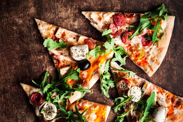 Hot pepperoni  pizza with salami and  cheese on rustic wooden table close up. Slice of hot pizza for lunch or dinner, top view with copyspace. Italian Fast Food.