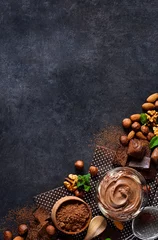 Tuinposter Black food background with cocoa, nuts and chocolate paste. top view © zefirchik06