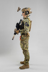 Special forces soldier with rifle on white background.