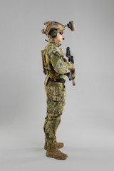 Special forces soldier with rifle on white background.