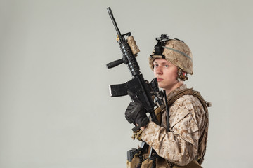 Soldier in camouflage holding rifle
