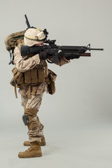 Soldier in camouflage holding rifle