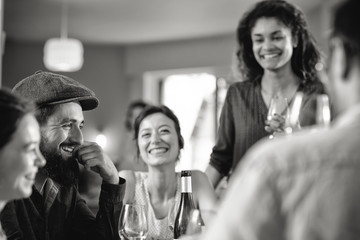 Mixed group of friends having fun while sharing a meal 