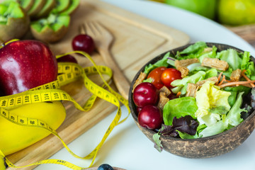 Colorful fruits are placed on many white tables. Strong fruit with vegetable salad and yellow waist line. Health Concerns.