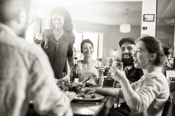 Mixed group of friends having fun while sharing a meal 