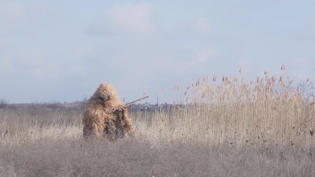 Slow Motion shooter in camouflage clothing silvan