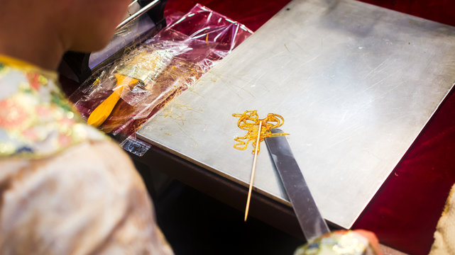 Person making a sugar candy painting