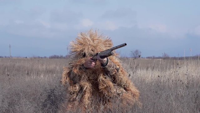 Slow Motion shooter in camouflage clothing silvan