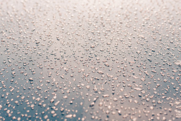 Frozen water droplets on the car, metal surface, winter snow frosty weather