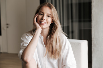 Lovely young woman dressed in white shirt