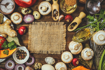 food ingredients. mushrooms, vegetables, spices. place for text. wooden background.