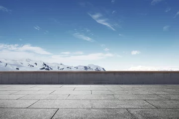 Photo sur Plexiglas Hiver empty brick ground with sonw mountain as background