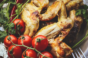 fried chicken wings on a metal plate.