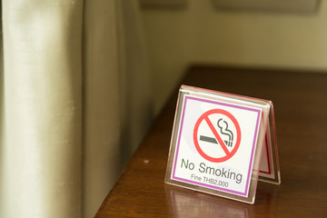 Do not smoke sign on table in room.Thailand.