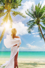 Cute woman relaxing on the summer beach.