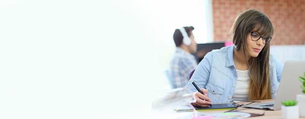 Young woman working with graphic tablet in office, template