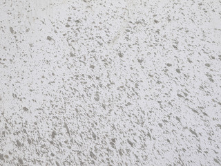 drops of mud on a white wall background