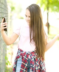 Girl is shooting photo using smartphone, outdoor shoot