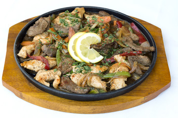 Bulgarian traditional cuisine. Sach of mixed meats and vegetables isolated on white background.