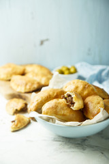 Homemade hand pies with minced meat and olives