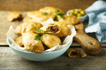 Homemade hand pies with minced meat and olives