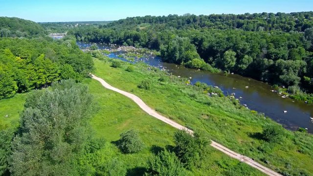 a beautiful summer landscape the drone flies out for a halm opening the view of the river