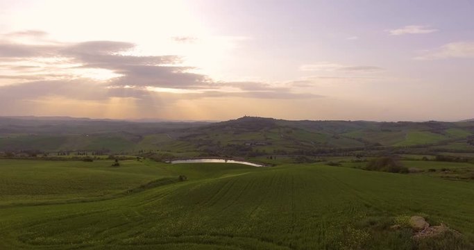 Aerial, beautiful landscape with hills and fields on sunset in Val d Orcia in Tuscany, Italy