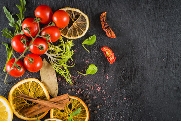 Different vegetables and spices on black background. Top view. Flatlay. Copy space