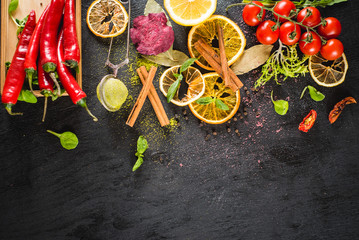 Different vegetables and spices on black background. Top view. Flatlay. Copy space