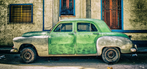 lateral view of old american car parked in a street of havana