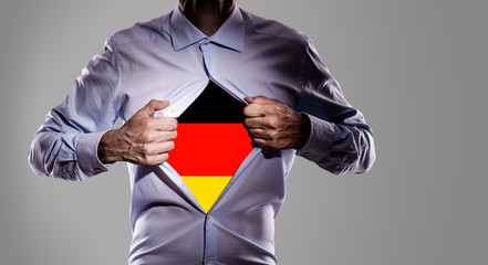 Business man with german flag on gray background  - 208901841