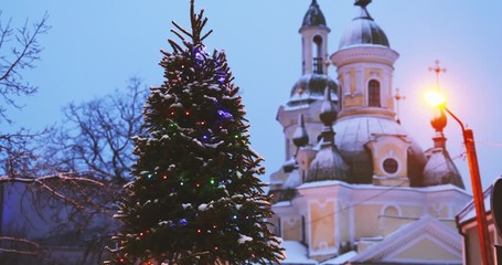 Parnu, Estonia. Christmas Tree In Holiday New Year Festive Illumination And St. Katherine Orthodox Church On Background
