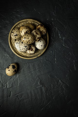 Quail Eggs on Dark Stone Background