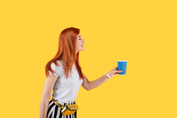Optimistic mood. Positive nice woman smiling while holding a coffee cup