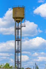 a water tower on a background of clouds