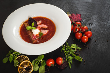 Red ukrainian soup borsch on black background