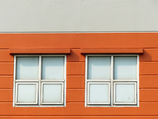 Window with frame on orange wall