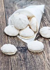 Crispy meringue on a wooden background.