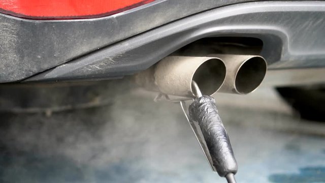 Checking and adjusting CO and CH content in vehicle.