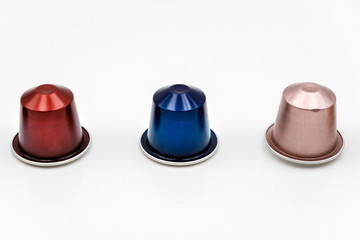 Three classic coffee capsules isolated on white background