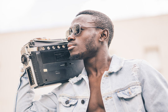 African man with vintage radio device.