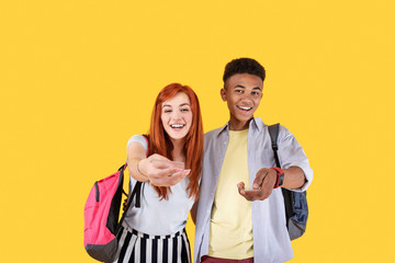 Join us. Cheerful delighted couple looking at you while offering to join them