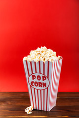 Red and White Bucket Of Popcorn on red background