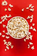 Red and White Bucket Of Popcorn on red background