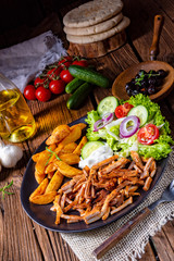 Rustic gyros plate it green salad and potato wedges