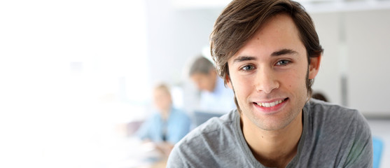 Portrait of smiling student in school class, template