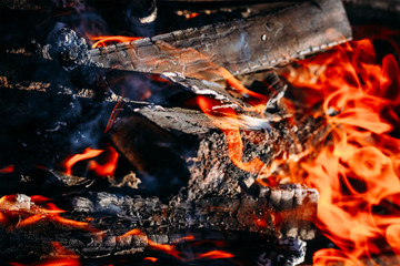 Burning charcoal embers firewood with ashes and flames