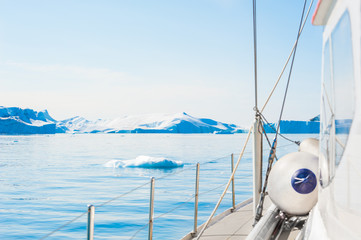 Yacht sailing among icebergs in Atlantic ocean in Greenland © smallredgirl