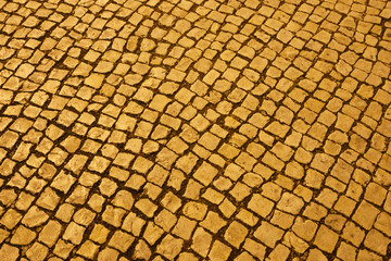 Textured yellow pavement illuminated at night