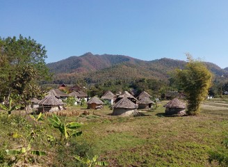 round native huts on field and mountains